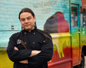 Sean Sherman standing in front of a food truck